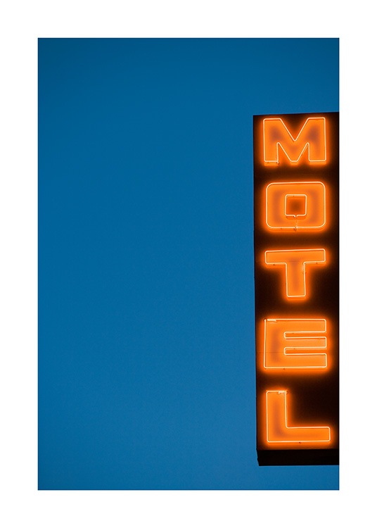  - Fotografia um sinal com luzes néon com o texto Motel contra um fundo azul escuro